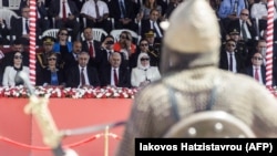 Turski lider na Kipru Mustafa Akindži (drugi sleva) i turski premijer Binali Jildirim (treći sleva) gledaju paradu vojnika obučenih u tradicionalnu vojničku odoru u Nikoziji