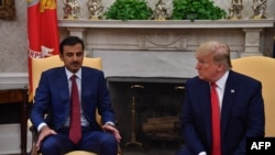 FILE: U.S. President Donald Trump meets with the Amir of Qatar Sheikh Tamim bin Hamad al-Thani in the Oval Office at the White House in Washington in July 9 2019.