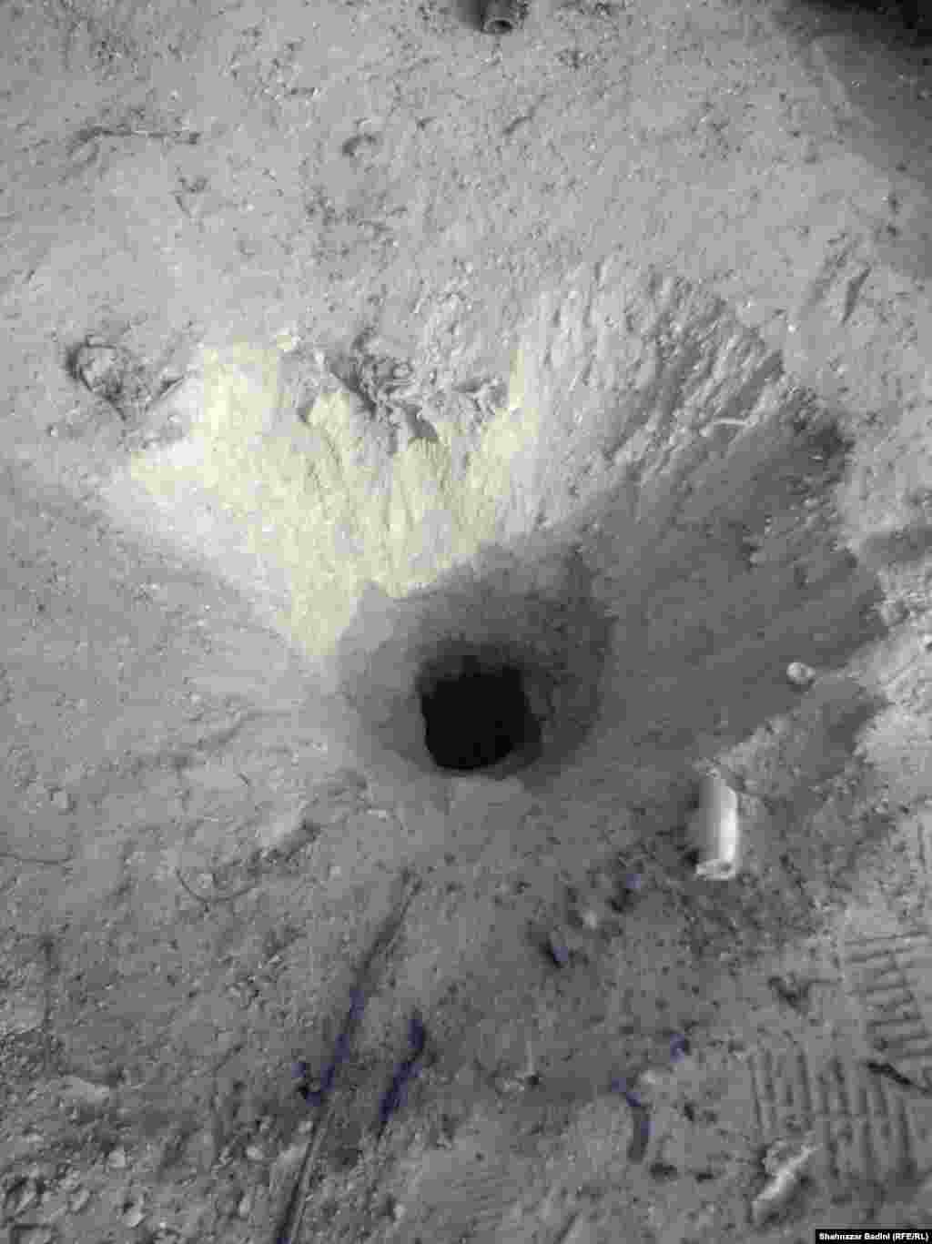 The hole made by the missile where it landed.