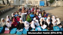 Afghan children attend an open-air class due to the lack of school facilities in the Sarhood district of Nangarhar Province on February 25.