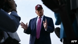 US President Donald Trump speaks to reporters after stepping off Air Force One at Joint Base Andrews in Maryland on June 10.