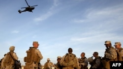 U.S. marines watch a U.S. helicopter gunship after landing to join the U.S. contingent at Camp Bastion in the southern Helmand Province. (file photo)