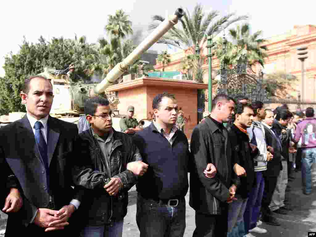 Protesters form a human chain around a Republican Guard tank in Cairo's Tahrir Square on January 29.