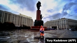 A municipal worker wearing a face mask and a protective suit to protect against the coronavirus disease disinfects a square near Lenin's monument in central Moscow on October 19.