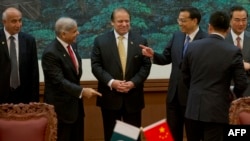 Chinese Premier Li Keqiang (3rd R) gestures near Pakistan Prime Minister Nawaz Sharif (C) and Punjab Chief Minister Shahbaz Sharif (2nd L) before a signing ceremony at the Great Hall of the People in Beijing in 2013. 