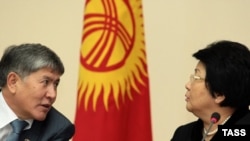 President Roza Otunbaeva (right) believes Prime Minister Almazbek Atambaev's government can survive Kyrgyzstan's traditionally turbulent spring.