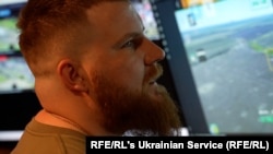 A Ukrainian soldier surveys screens relaying drone-camera images of Russian positions that can be targeted by artillery. 