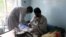 An Afghan lecturer of Kandahar University receives medical treatment at a hospital after he was release by unknown gunmen, in Ghazni, June 10, 2014