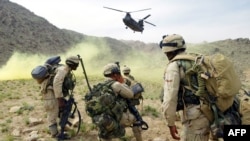 FILE: U.S. soldiers prepare to board a helicopter after Operation Deliberate Strike some 60 kilometers north of Kandahar.