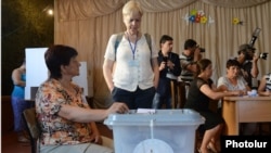 A foreign observer monitors voting at a polling station in Stepanakert, Nagorno-Karabakh, on July 19. 