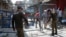 Police officers put up barriers as they guard a street sealed after authorities reimposed lockdowns in selected areas in an effort to stop the spread of the coronavirus disease in the eastern city of Lahore on June 17.