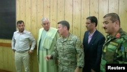 FILE: Police Chief of Kandahar General Abdul Raziq (L), Governor of Kandahar Zalmay Wesa (2nd L) and Commander of NATO forces in Afghanistan U.S. General Scott Miller (C) during the October 18 meeting.