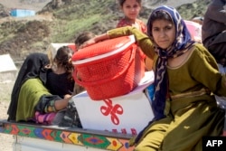 یوه افغانه کورنۍ له پاکستانه تر ایستل کېدو وروسته د ننګرهار ولایت په تورخم کې د لنډمهالي کیمپ پر لوري روانه ده - د اپرېل اوومې انځور.