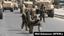 FILE: NATO troops on a street in the Afghan capital Kabul after a Taliban suicide attack on NATO convoy wounded three civilians in September 2017.