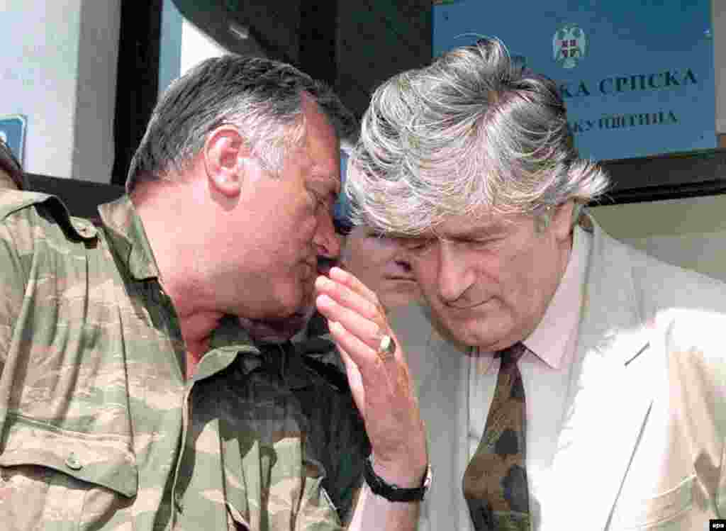 Bosnian Serb Commander Ratko Mladic speaks to Bosnian Serb leader Radovan Karadzic during a meeting in Pale, Bosnia and Herzegovina, on August 5, 1993. &nbsp;Both men are currently in custody and on trial for war crimes at the International Criminal Tribunal in The Hague.