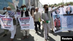Former Afghan interpreters who worked with U.S. troops in Afghanistan demonstrate in front of the U.S. Embassy in Kabul on June 25.