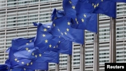 EU flags fly outside the bloc's headquarters in Brussels.