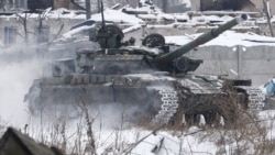 Ukrainian servicemen ride in a tank close to the airport in the eastern city of Donetsk, a facility which has been the site of intense fighting for several weeks.