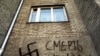 An anti-Semitic slogan and a Nazi swastika drawn on a house in Vladivostok, Russia.