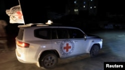 Газадагы туткундардын сөөгүн алып бараткан Кызыл Чырым уюмунун автоунаасы.