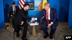  Ukrainian President Volodymyr Zelenskyy (left) shakes hands with US President Donald Trump during their meeting on the sidelines of the NATO summit in The Hague on June 25. 