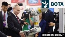 Russian President Vladimir Putin visits an exhibition at the Harbin Institute of Technology in Harbin as part of a 2024 state visit to China. 