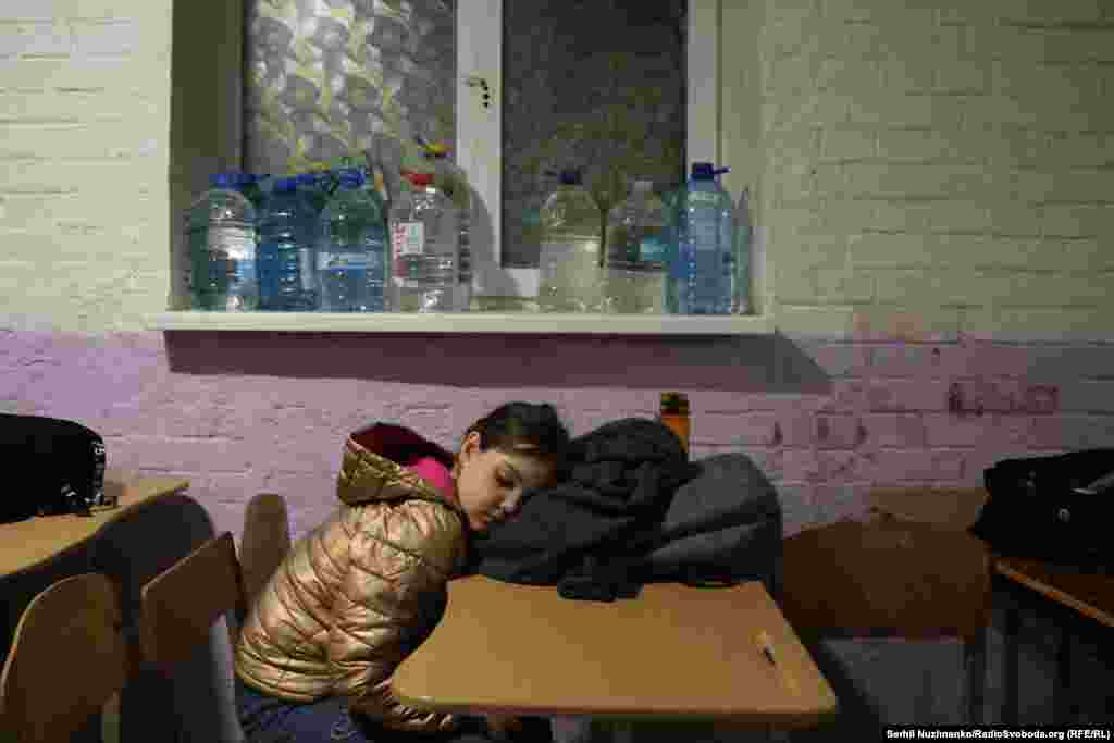 A girl sleeps in a bomb shelter following the attack.