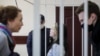 Sofya Malashevich (center) and Tsikhan Klyukach (right) in court on January 14