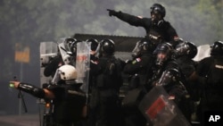 Serbian security forces at an anti-government protest near the Serbian Progressive Party office in Belgrade on August 15 