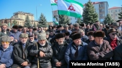 Local people hold Ingushetian flags as they attend a rally to protest against a controversial border deal with neighboring Chechnya in Magas on March 26, 2019.