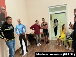 Supporters pose with a cardboard cutout of Andrei Pivovarov.