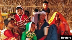 Hindu immigrant woman and children from Pakistan sit at a shelter in Rajasthan, India.