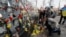 People place flowers at the memorial dedicated to people who died in the 2014 clashes with security forces on Kyiv's Independence Square on February 18, 2020.