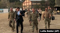 U.S. Defense Secretary Mark Esper (center) walks with Gen. Scott Miller, (right), chief of the U.S.-led coalition in Afghanistan, at the U.S. military headquarters in Kabul on October 20.