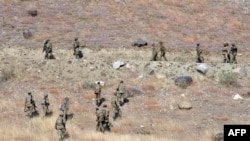 FILE: Pakistani troops climb a hill in Ladha, a rural region in South Waziristan district.