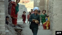 An Afghan youth carries bread for Iftar, the meal for breaking the fast during the Muslim holy month of Ramadan on the outskirts of Jalalabad.