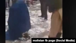 A screen grab from an amateur video of a mob beating an Afghan woman in Takhar Province because she allegedly had an extramarital affair. The woman survived the incident. 
