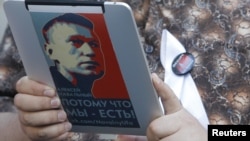 An opposition activist uses an electronic device with a portrait of prominent anticorruption blogger Aleksei Navalny during a protest in central Moscow last week.
