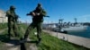 Russian soldiers guard a pier where two Ukrainian naval vessels are moored in Sevastopol, Ukraine, in March 2014.