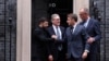 Ukrainian President Volodymyr Zelenskyy (left) shakes hands with French President Emmanuel Macron in front of 10 Downing Street after a meeting in London that was also attended by UK Prime Minister Keir Starmer (second left) and German Chancellor Friedrich Merz (right) on December 8