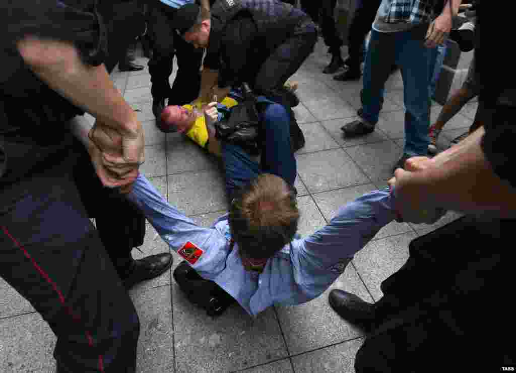 Police officers separate Orthodox and gay-rights activists outside the State Duma.