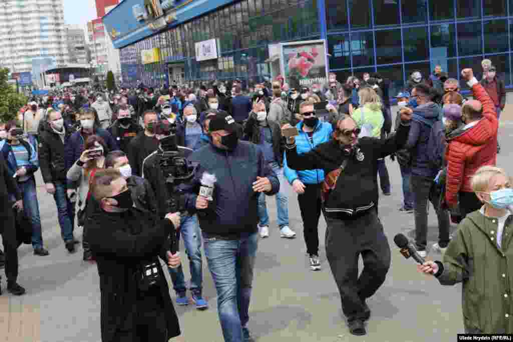 Opposition activist and blogger Syarhey Tsikhanouski (center) walks with his supporters during a rally. He was one of the organizers of the May 24 demonstration and was recently jailed over a previous "unsanctioned mass gathering." Tsikhanouski's candidacy to run in the presidential vote was rejected by the authorities.