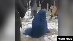 Afghanistan - screen grab from amateur video of a mob beating a woman in Tarkhan Province because she allegedly had an extramarital affair. video screen grab