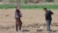Uzbek farmers work in the field in spring in Karakalpakstan, Uzbekistan, Central Asia - April 2019