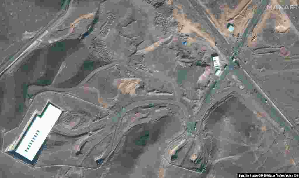 Trucks and bulldozers are seen near the entrance to the Fordow underground facility prior to the strike. Iran claimed that it had removed material from Fordow and the other targeted sites before they were hit. President Trump claimed the US strikes "obliterated" key Iranian nuclear sites. 