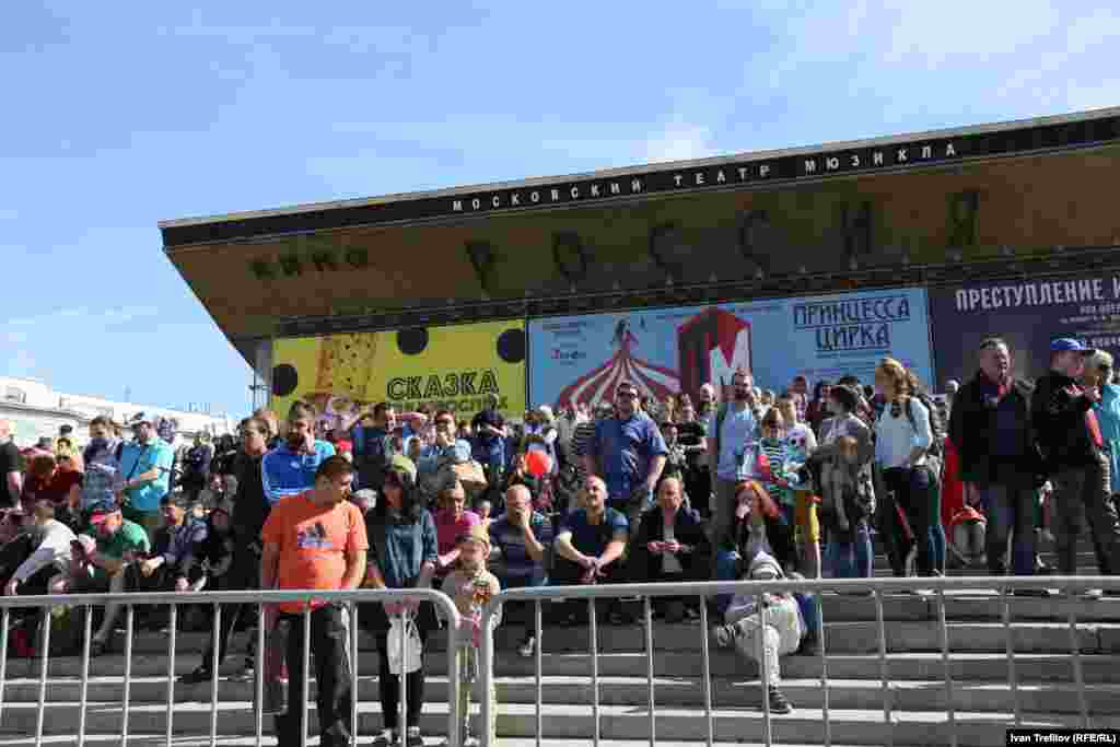 Часть зрителей удачно расположилась на ступенях кинотеатра "Россия", ближе им подойти также не разрешают
