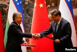 Ўзбекистон президенти Шавкат Мирзиёев ва Хитой етакчиси Си Цзинпин. "Хитой - Марказий Осиё" саммитида олинган сурат. Сиан шаҳри. 2023 йил.