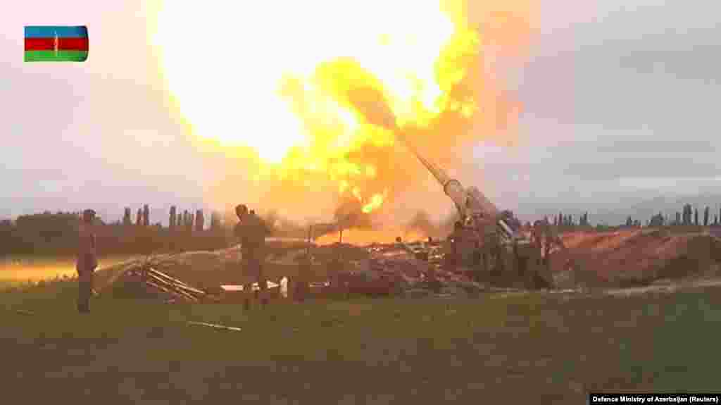 A still image from a video released by Azerbaijan's Defense Ministry shows members of the Azerbaijani armed forces firing artillery in an unidentified location.