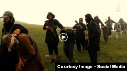 FILE: An Islamic State propaganda video released in August 2015 show bound and blindfolded Afghan prisoners being taken away by IS fighters.