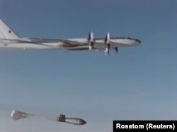 A modified Tupelov Tu-95 drops Tsar Bomba, trailed by its massive parachute, in a test over the remote Novaya Zemlya archipelago in the U.S.S.R.